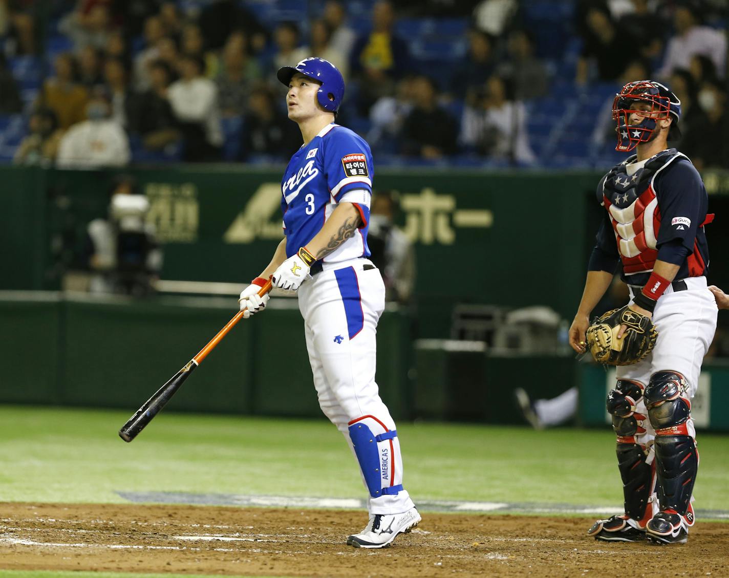 South Korea&#x2019;s Park Byung-ho watches the flight of his three-run home run with USA catcher Dan Rohlfing in the fourth inning of their final game at the Premier12 world baseball tournament at Tokyo Dome in Tokyo, Saturday, Nov. 21, 2015.