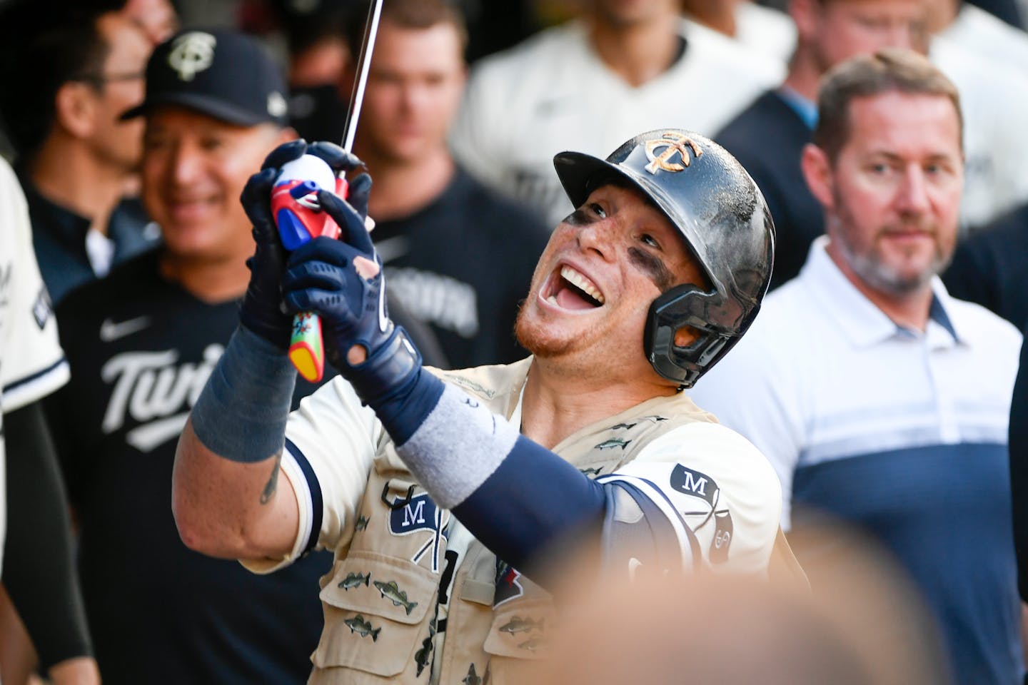 Minnesota Twins' Christian Vazquez celebrates with a fishing vest and reel after hitting a three-run home run against Boston Red Sox pitcher James Paxton during the fifth inning of a baseball game, Monday, June 19, 2023, in Minneapolis. (AP Photo/Craig Lassig)