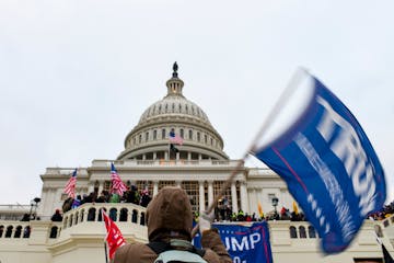 FILE - Members of a pro-Trump mob that invaded the Capitol in Washington, Jan. 6, 2021. A member of the far-right nationalist Proud Boys was in commun