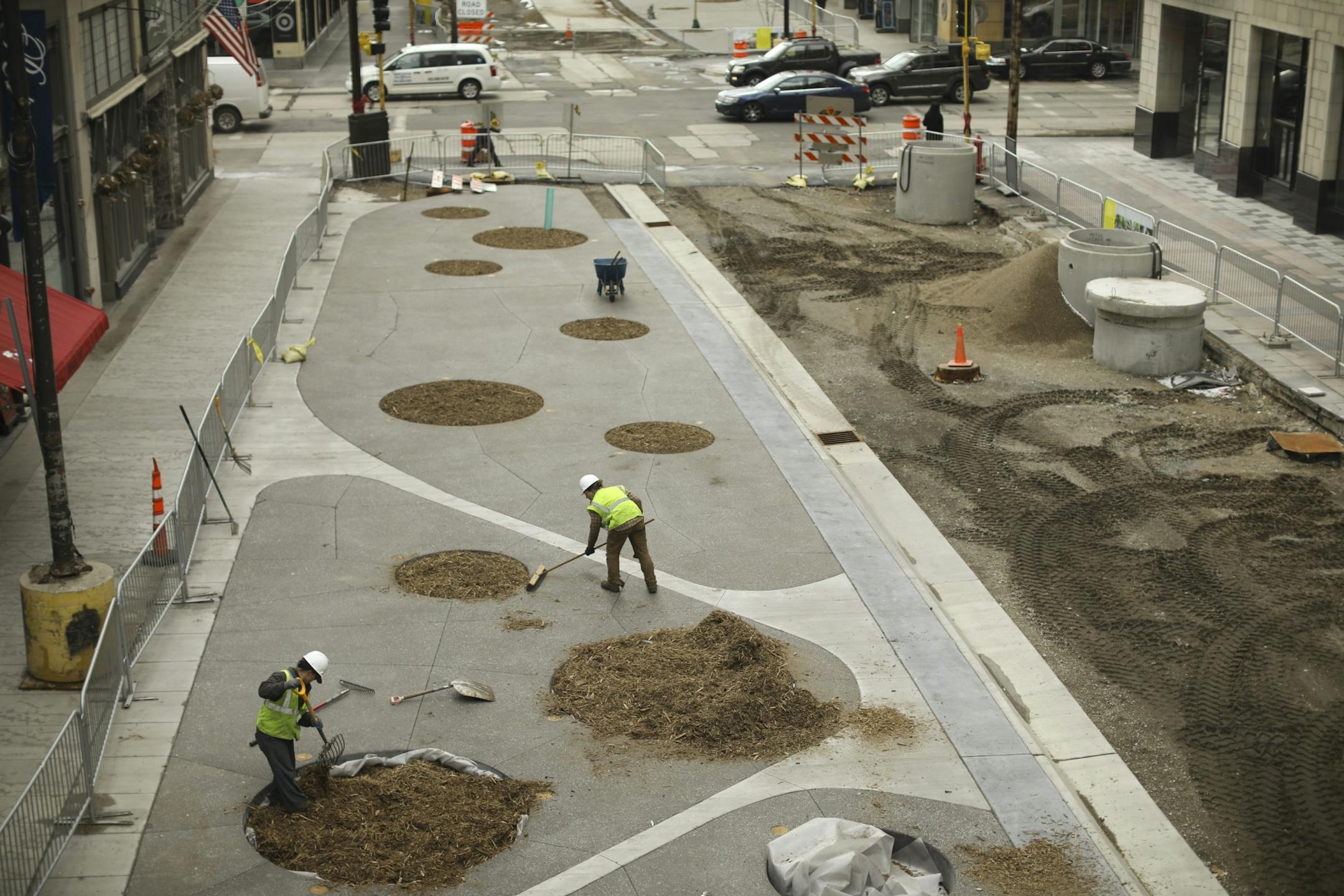 Jen Merth, field manager for Wetland Habitat Restorations, forked mulch around a bed in the 900 block of the Nicollet Mall that will be planted with either an oak or birch tree in coming months.