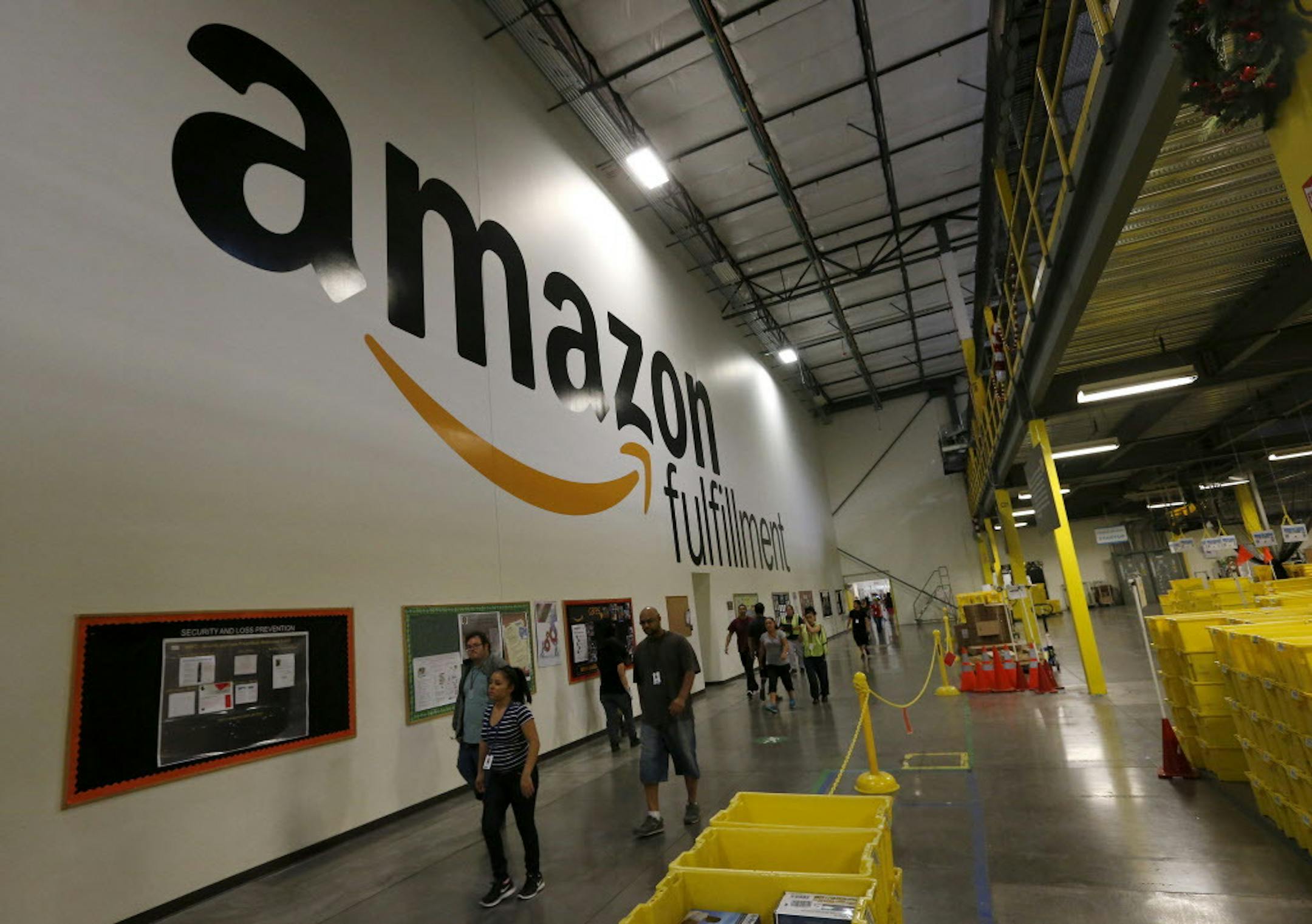 Amazon.com employees go back to work after a short break at an Amazon.com Fulfillment Center on "Cyber Monday" on the busiest online shopping day of the holiday season Monday, Dec. 2, 2013, in Phoenix. (AP Photo/Ross D. Franklin)