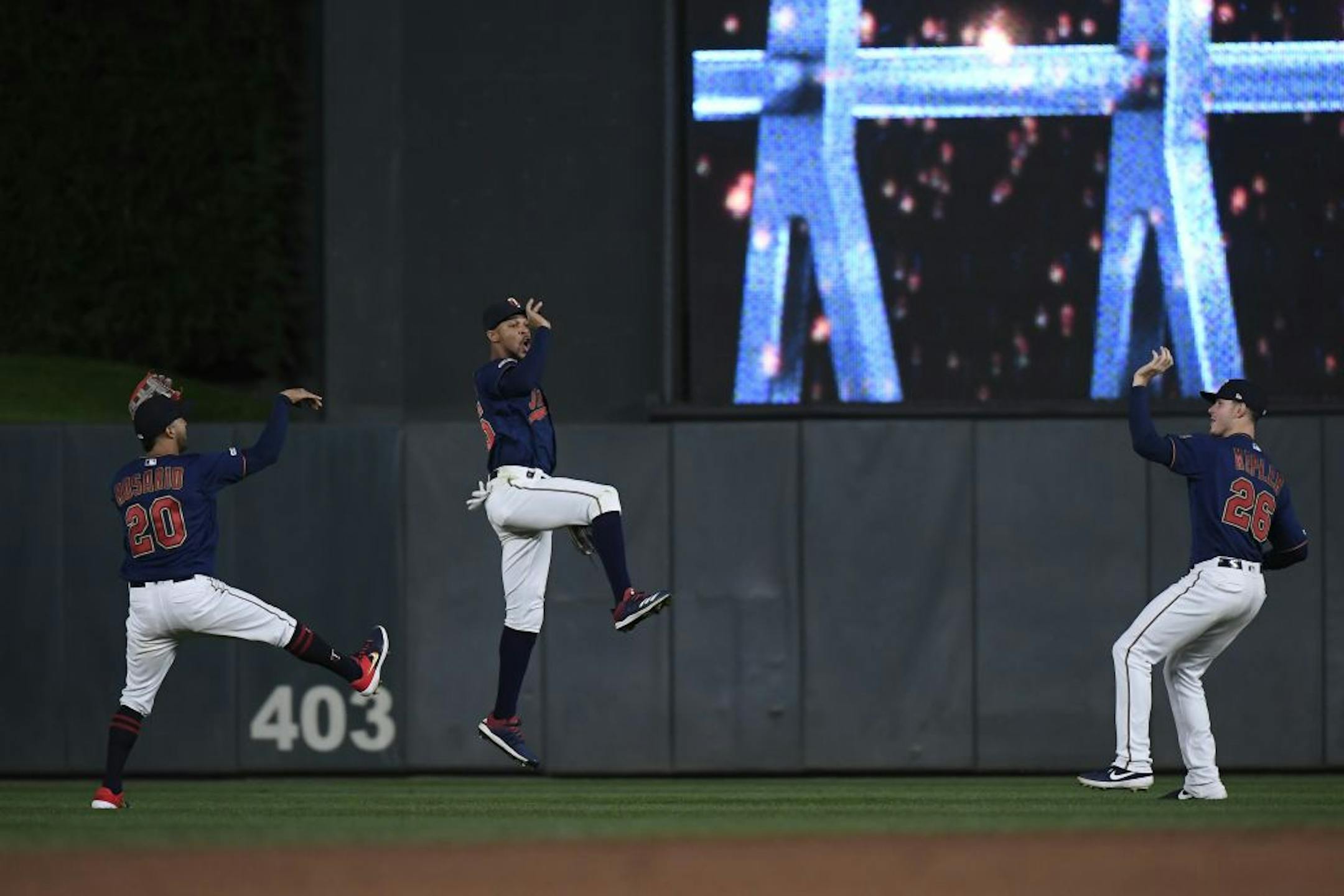 From left, Minnesota Twins left fielder Eddie Rosario (20), center fielder Byron Buxton (25) and right fielder Max Kepler (26) celebrated their 8-3 win over the Detroit Tigers.