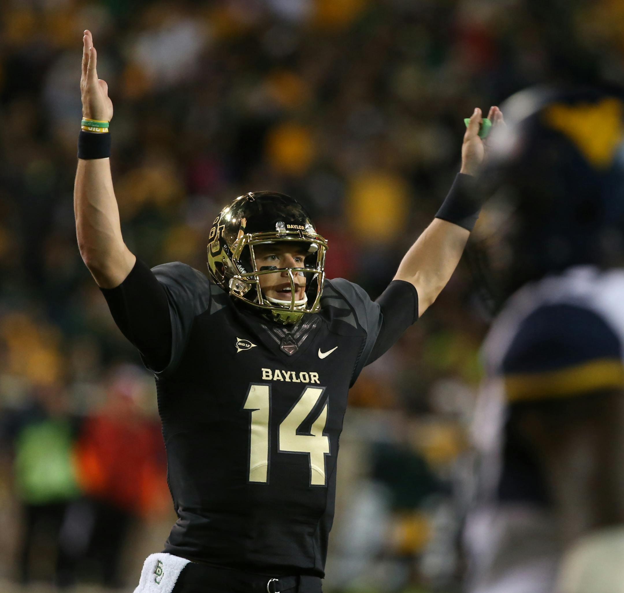 Baylor quarterback Bryce Petty (14), holds up his hands after a touchdown against West Virginia during the first half of an NCAA college football game on Saturday, Oct. 5, 2013, in Waco, Texas. (AP Photo/Rod Aydelotte) ORG XMIT: TXRA118