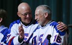 Jack O'Callahan, left, and Mark Pavelich of the 1980 U.S. ice hockey team talk during a "Relive the Miracle" reunion at Herb Brooks Arena on Saturday,