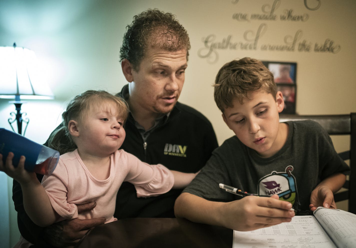 Alex Kempe helps his oldest son Aiden,9, with his math homework while youngest Sabriella,2, gets in on the action. ] "It's fulfilling," says Iraq veteran Alex Kempe about raising his three kids and giving them unconditional love. He says he is building something instead of destroying things like he did in the military. He went through Ramsey County's veterans court, which he credits for helping turn his life around. Richard Tsong-Taatarii&#x2022;Richard.Tsong-Taatarii@startribune.com