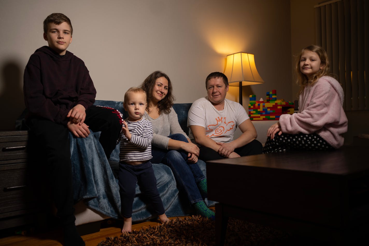 Recent Ukrainian immigrants Olesia Safronova, her husband, Serhii Chubenko, and their children, Timur, 2, Milana, 8, and Damir, 14, gathered for a portrait in their St. Paul home Thursday night, February 23, 2023. The family fled Ukraine when the war broke out one year ago and lived in Italy as refugees until December, when they came to Minnesota with the help of Alight, a MN based refugee assistance nonprofit. ] JEFF WHEELER • jeff.wheeler@startribune.com