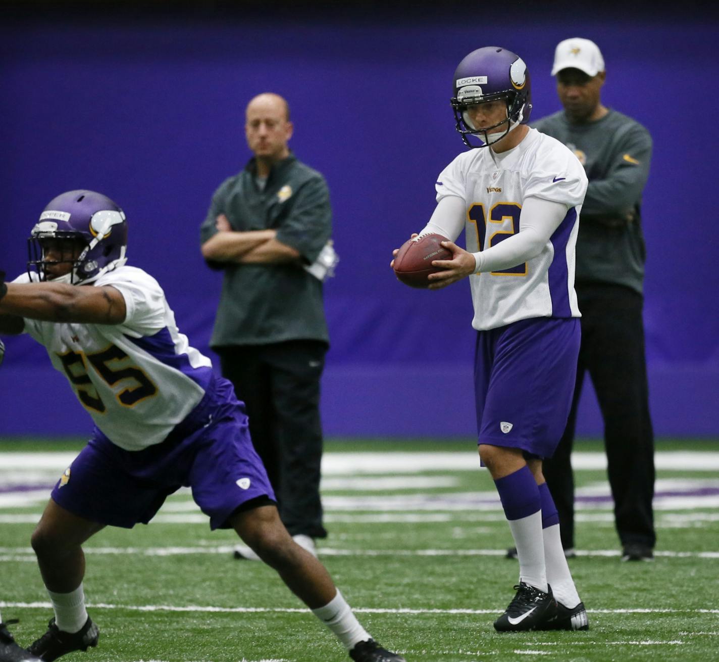 Punter Jeff Locke is watched closely by Coach Leslie Frazer.