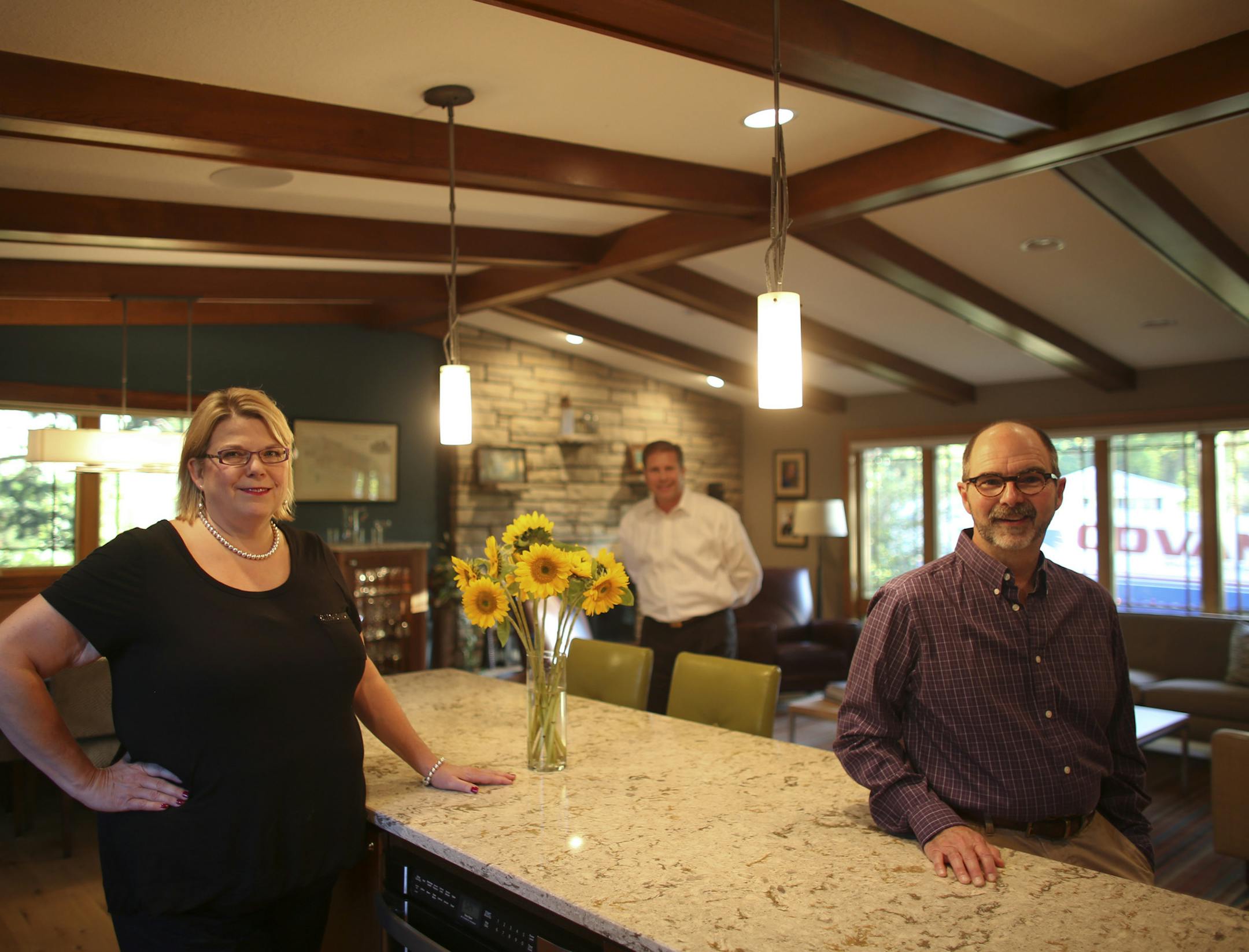 Dennis and Shelly Zuzek updated the kitchen, dining, and living rooms of their 1960's era home in Edina with the help of builder Bjorn Freudenthel. Shelly and Dennis Zuzek, foreground, with their builder, Bjorn Freudenthel, rear, photographed in their remodeled kitchen Wednesday evening, October 9, 2013. ] JEFF WHEELER ‚Ä¢ jeff.wheeler@startribune.com