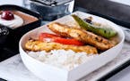 In a photo provided by Turkish Airlines, a gluten-free meal offered in economy class on Turkish Airlines: chicken breast over rice, with a caprese sal