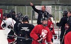 Eden Prairie Hockey Coach Lee Smith works with his players during practice Tuesday afternoon.] The Eden Prairie boys hockey team welcomes three new st