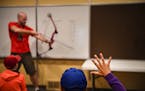 Noah Pierson, 9, of Inver Grove Heights, raised his hand to ask a question as class instructor Jared Little taught basic archery form.
