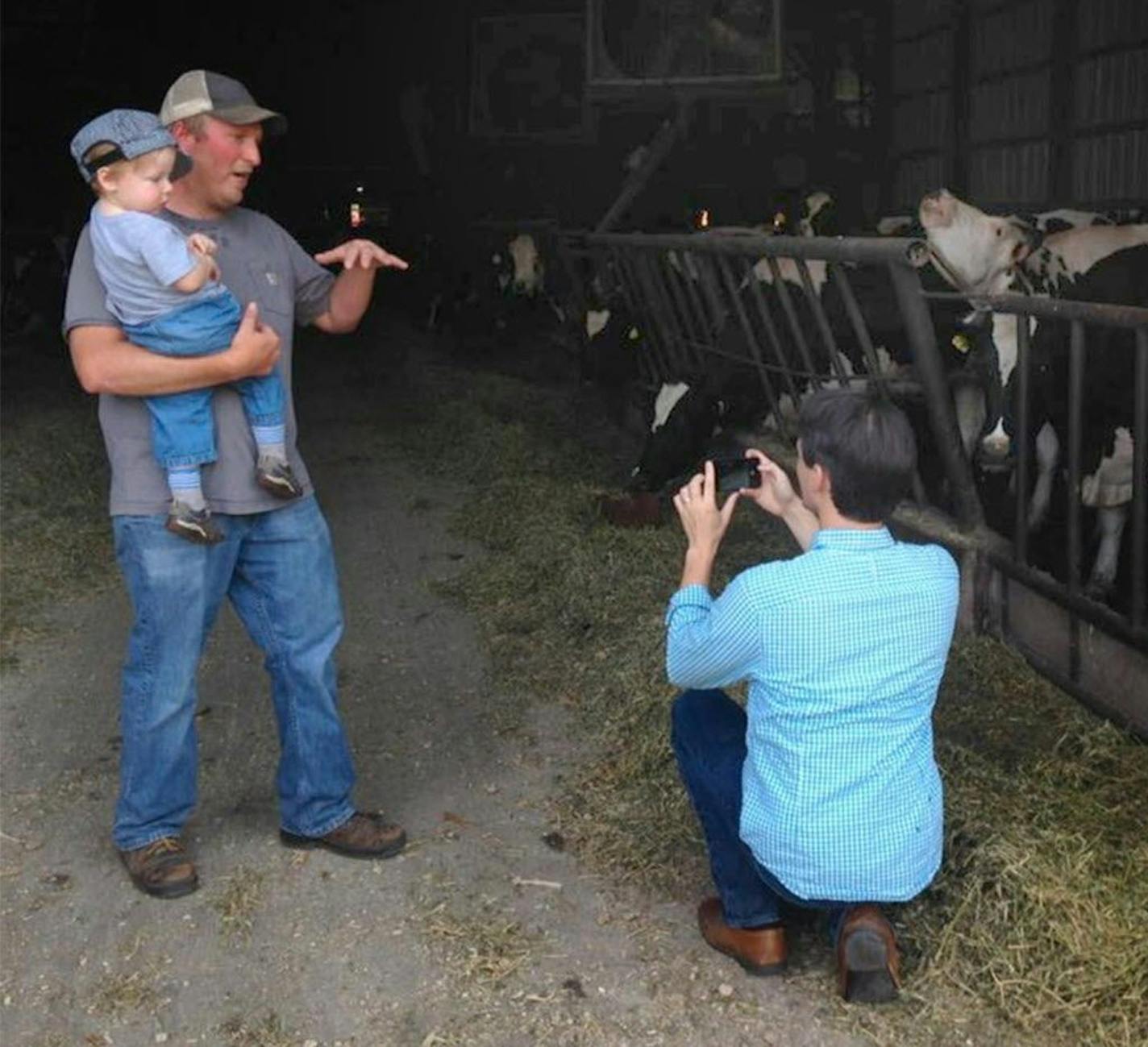 Washington Post reporter Christopher Ingraham takes photos at a dairy farm during a tour of Red Lake County.