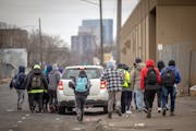 Ecuadorians chased a car hoping for work in Minneapolis on Feb. 7.