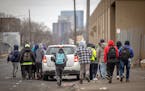 Ecuadorians chased a car hoping for work in Minneapolis on Feb. 7.