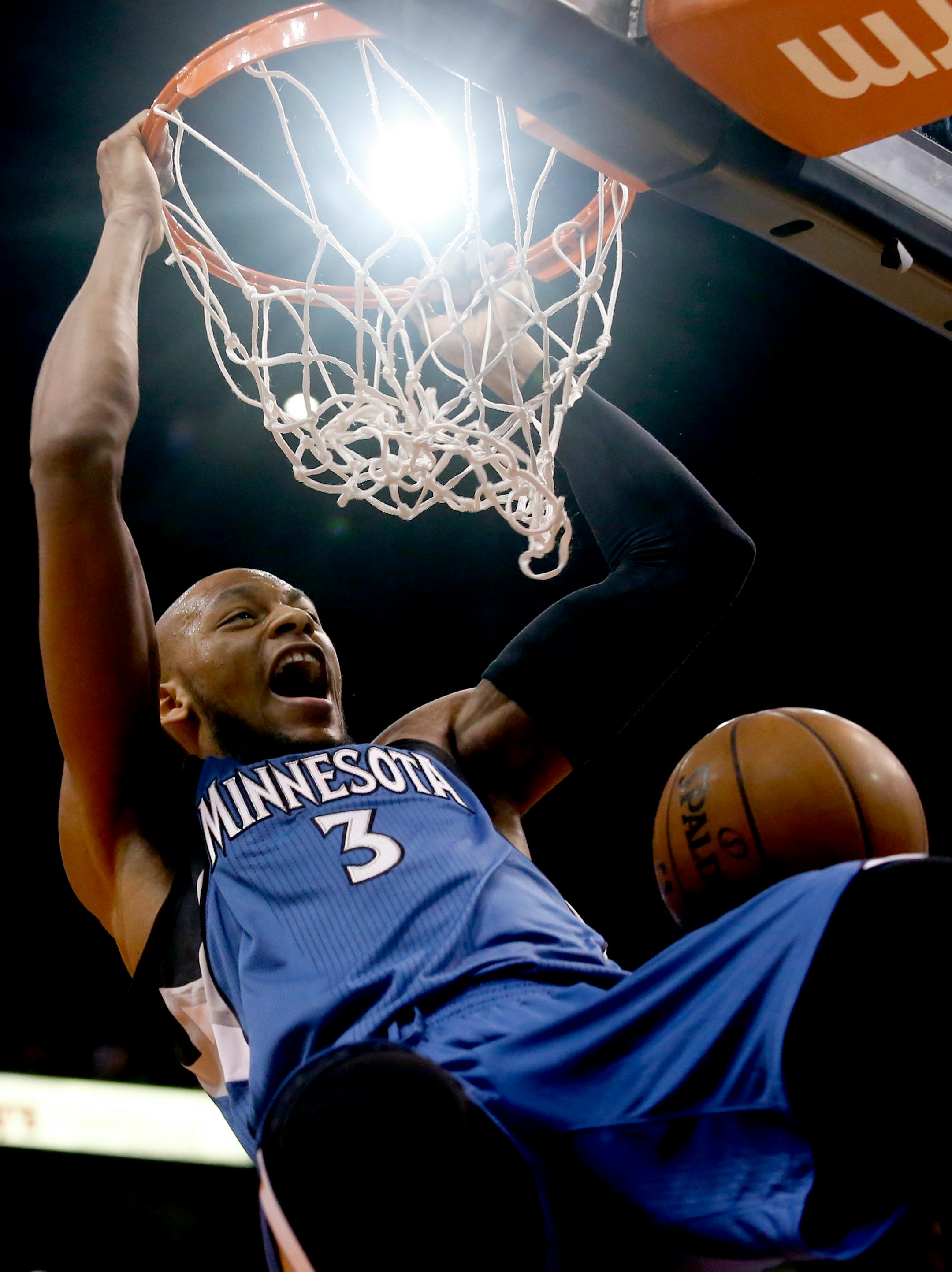 Minnesota Timberwolves forward Adreian Payne (3) dunks against the Phoenix Suns in the first quarter during an NBA basketball game, Wednesday, March 11, 2015, in Phoenix. (AP Photo/Rick Scuteri)