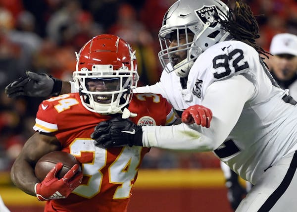 FILE - In this Dec. 1, 2019, file photo, Kansas City Chiefs running back Darwin Thompson (34) gets past Oakland Raiders defensive tackle P.J. Hall (92
