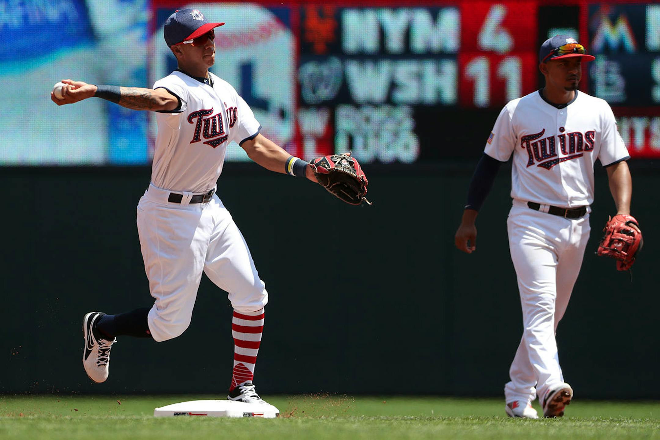 Minnesota Twins shortstop Ehire Adrianza (16) made the throw to first after fielding the ball to get out Los Angeles Angels shortstop Andrelton Simmons (2) in the second inning.