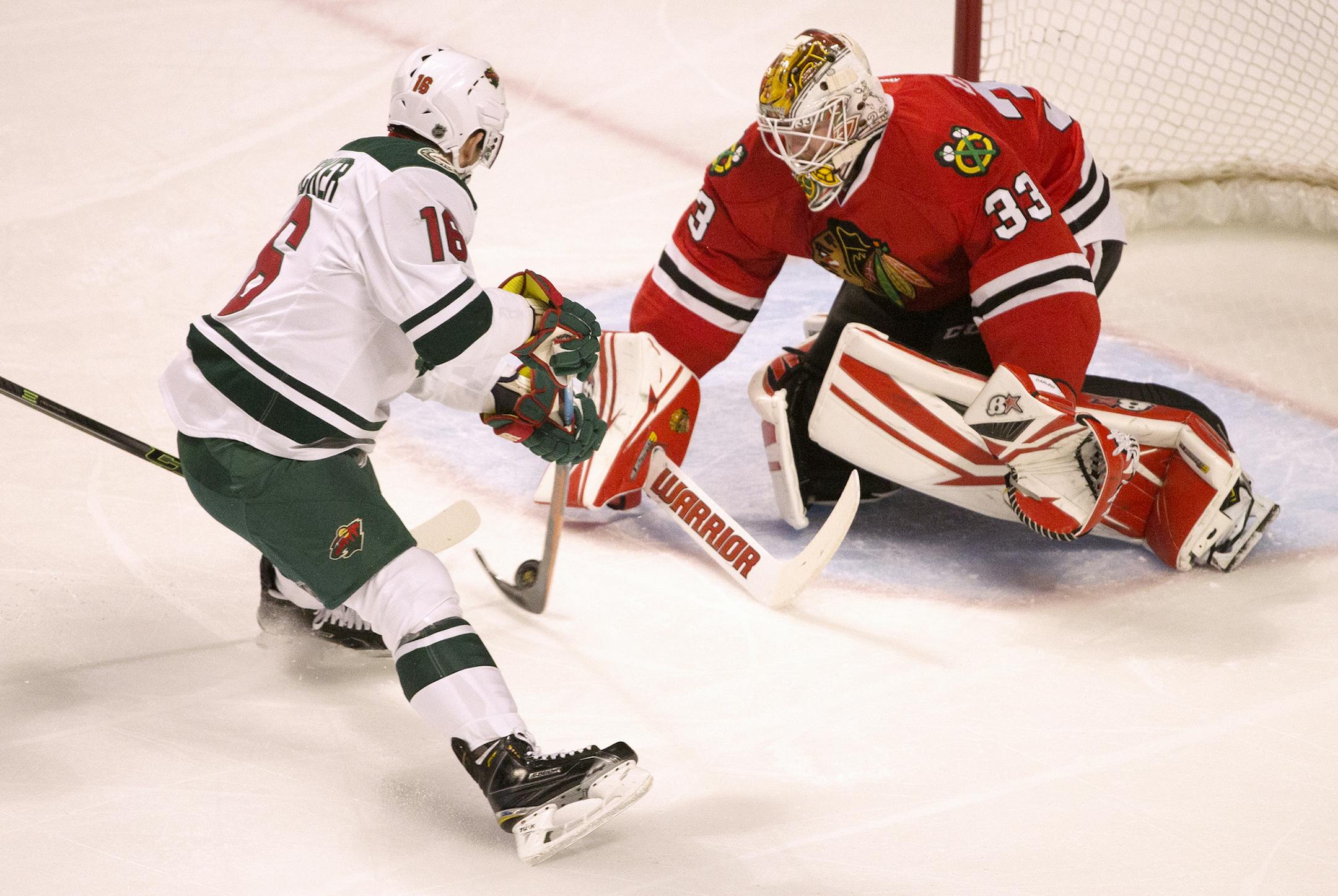 Chicago Blackhawks goalie Scott Darling (33) blocks a shot from Minnesota Wild left wing Jason Zucker (16) during the first period on Sunday, March 20, 2016, at the United Center in Chicago. (Erin Hooley/Chicago Tribune/TNS) ORG XMIT: 1182256