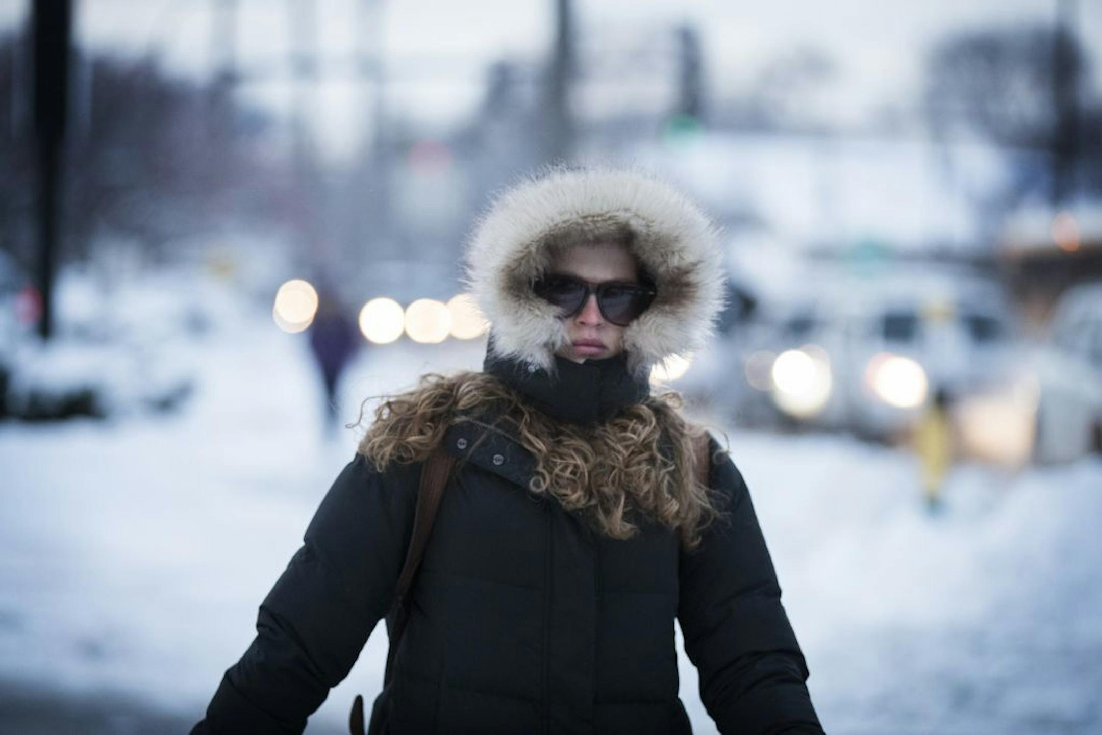 Abby McCall crosses Riverside Avenue while bundled against the cold Minneapolis morning.