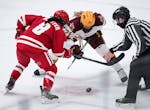 Minnesota forward Emily Oden (21) and Wisconsin forward Makenna Webster (8) went for a face off in the first period. ] ANTHONY SOUFFLE • anthony.sou