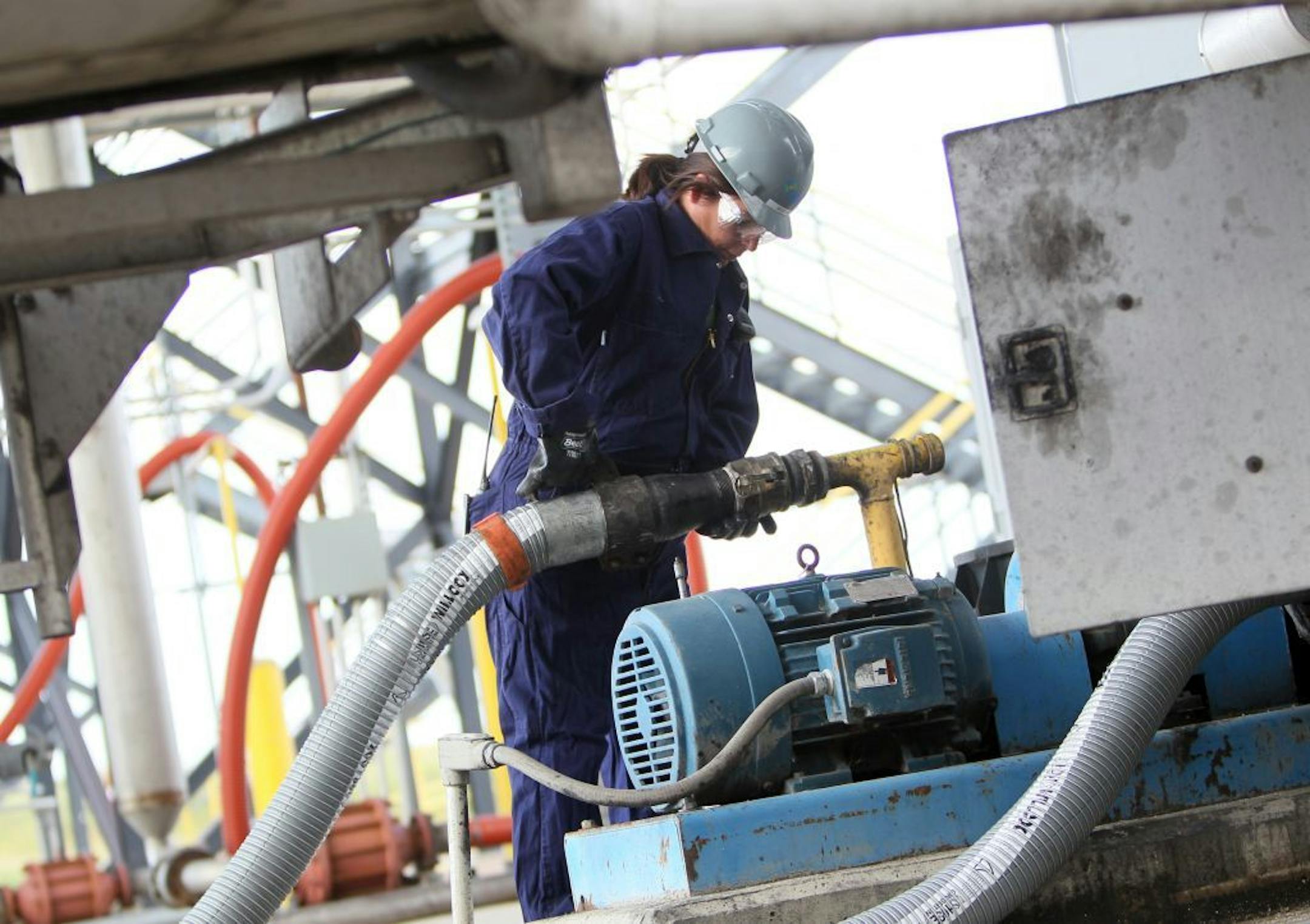 REG biodiesel plant employee Becky Williams detached a tube that emptied oil from a truck into the plant to be made into biodiesel fuel in Glenville, Minn. on Thursday, August 18, 2011.