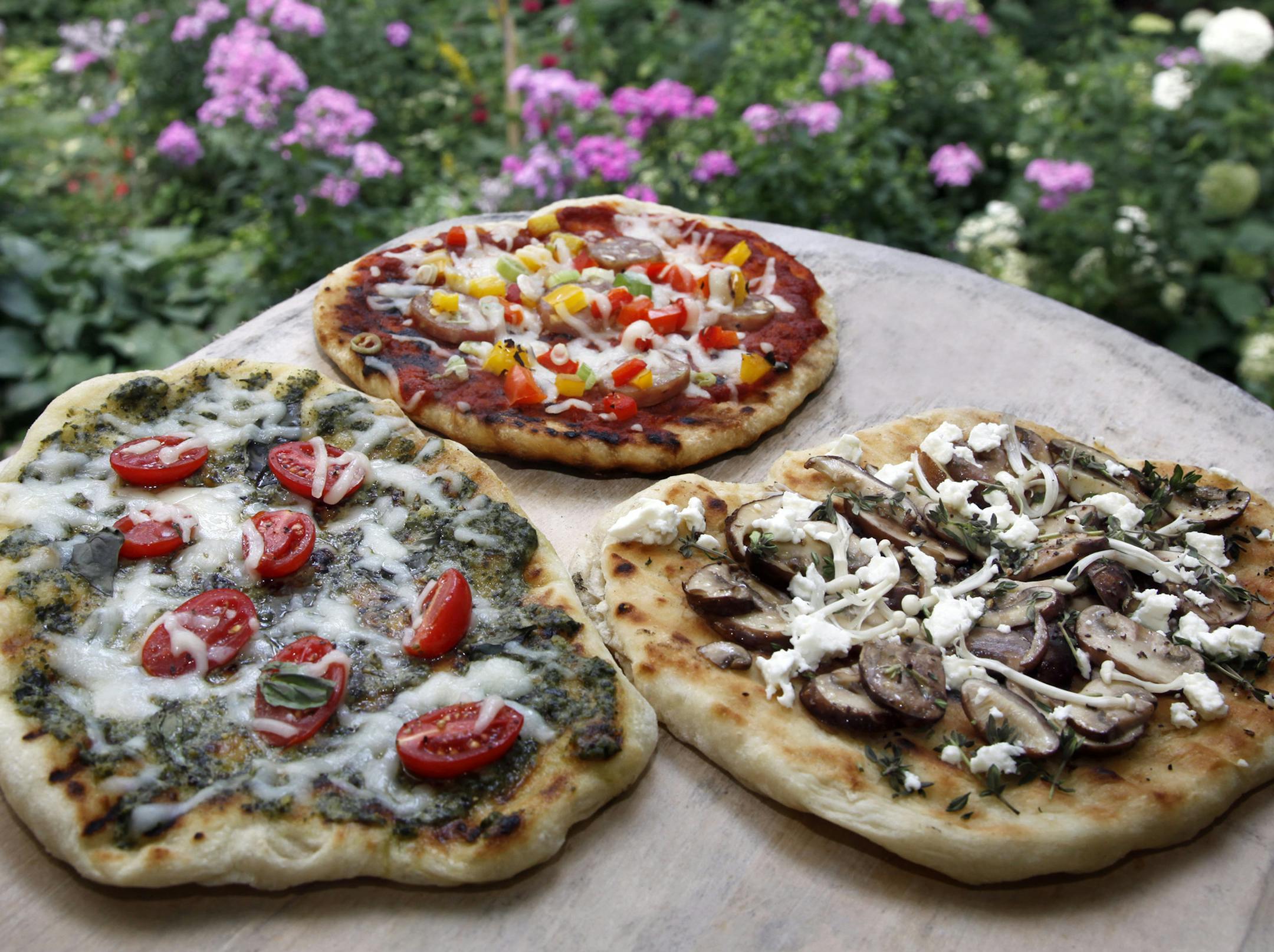 TOM WALLACE • twallace@startribune.com Assignment #20013245A Slug: pizza072210 Date: July 13, Illustrate cooking pizza on outdoor grill< kim Ode’s home kitchen _THIS PHOTO: ] Next in Baking Central production, how to steps and illustrations. This one is on grilled pizza outdoors, with a variety of toppings.