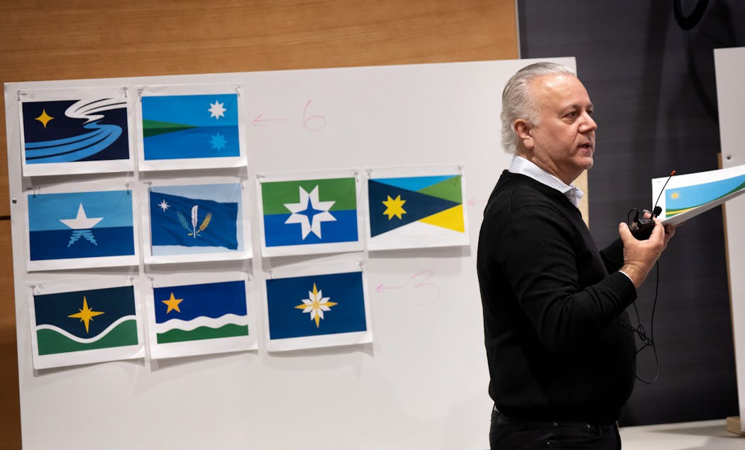 Commission chair Luis Fitch started the discussion of the highest-ranked flag designs, seen behind him at Tuesday’s meeting.