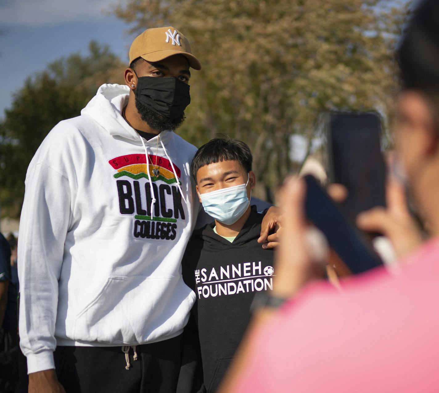 Timberwolves player Karl-Anthony Towns posed for a photo with Matthew Tha during the event at the Tony Sanneh Foundation in St. Paul. ] JEFF WHEELER • jeff.wheeler@startribune.com Timberwolves players, coaches, and staff stopped to visit the George Floyd memorial at E. 38th St. and Chicago Ave. S. in Minneapolis Tuesday afternoon, October 6, 2020 before heading to St. Paul to take part in a get out the vote initiative.