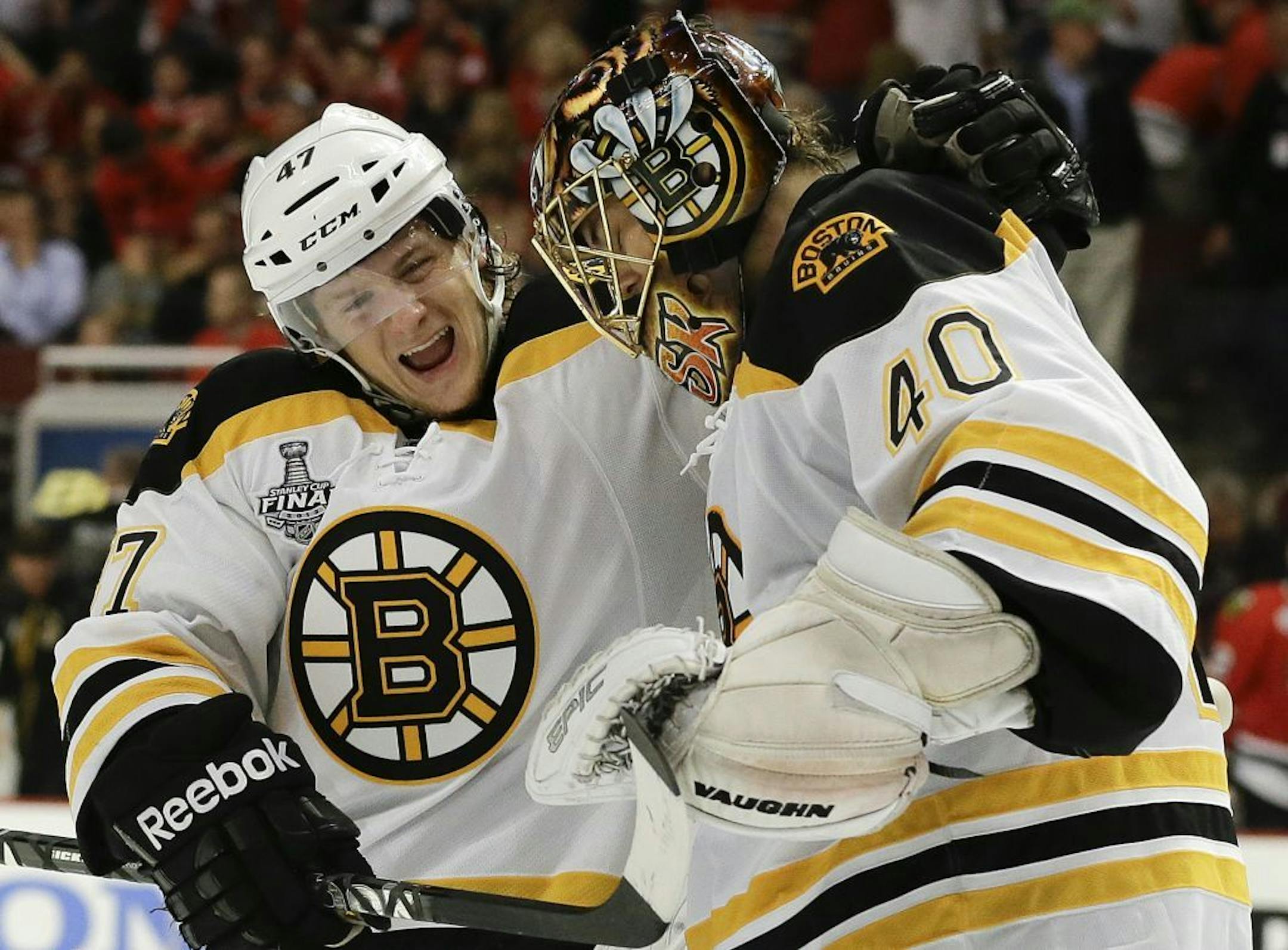 Boston Bruins defenseman Torey Krug (47) celebrates with goalie Tuukka Rask (40) after the Bruins scored a goal against the Blackhawks in overtime during Game 2 of the NHL Stanley Cup Finals