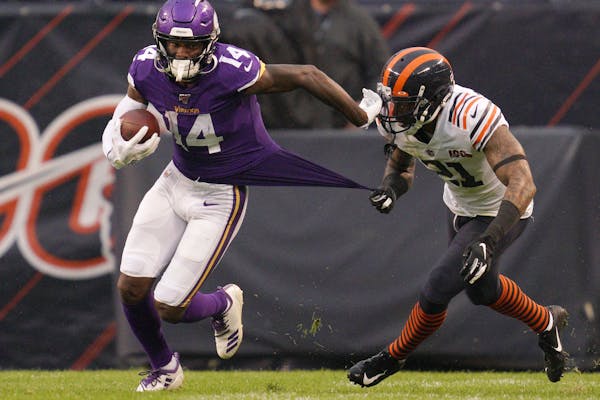 Minnesota Vikings wide receiver Stefon Diggs (14) raced down the field with the ball as Chicago Bears strong safety Ha Ha Clinton-Dix (21) pulled on h