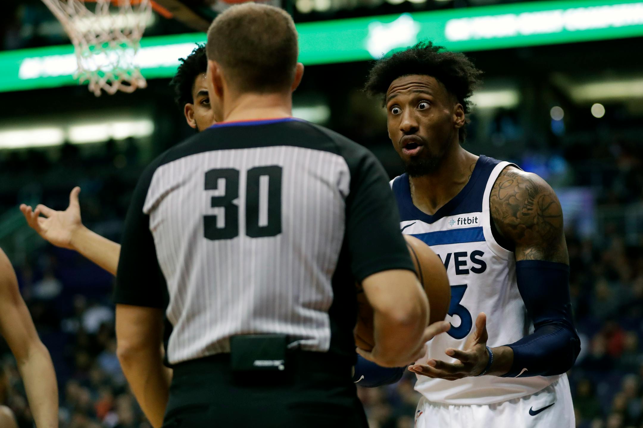 Minnesota Timberwolves forward Robert Covington, right, argues a call with referee John Goble (30) during the second half of an NBA basketball game against the Phoenix Suns, Monday, Dec. 9, 2019, in Phoenix. (AP Photo/Matt York)