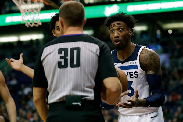 Minnesota Timberwolves forward Robert Covington, right, argues a call with referee John Goble (30) during the second half of an NBA basketball game ag