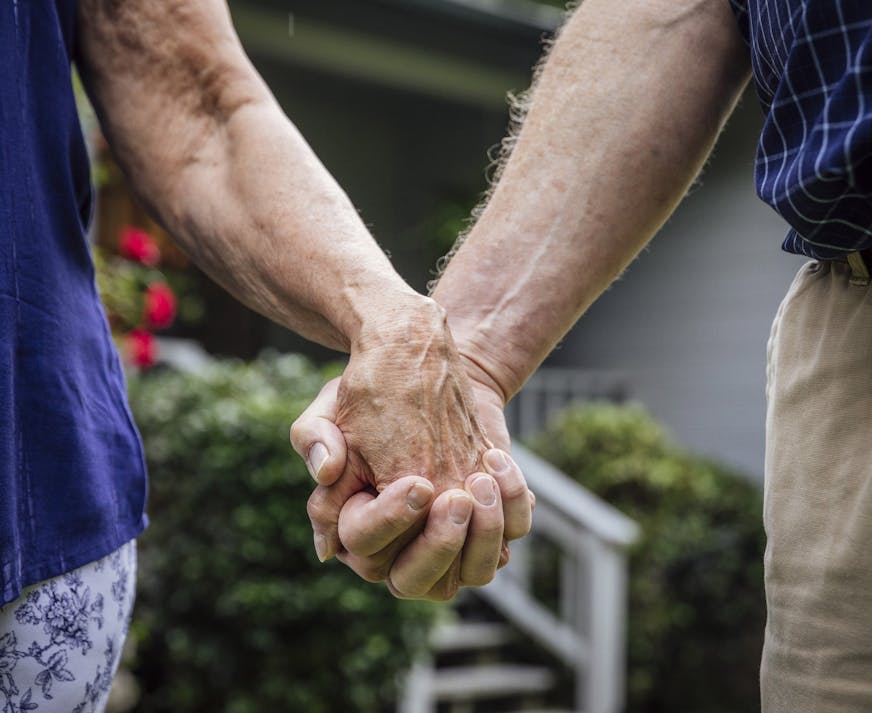 FILE -- Glenn and LouJean Nelson hold hands in Tallahassee, Fla., May 26, 2018. There are steps retirees can take to lengthen the life of their savings, such as mindful spending, when markets are less than cooperative. (Audra Melton/The New York Times)