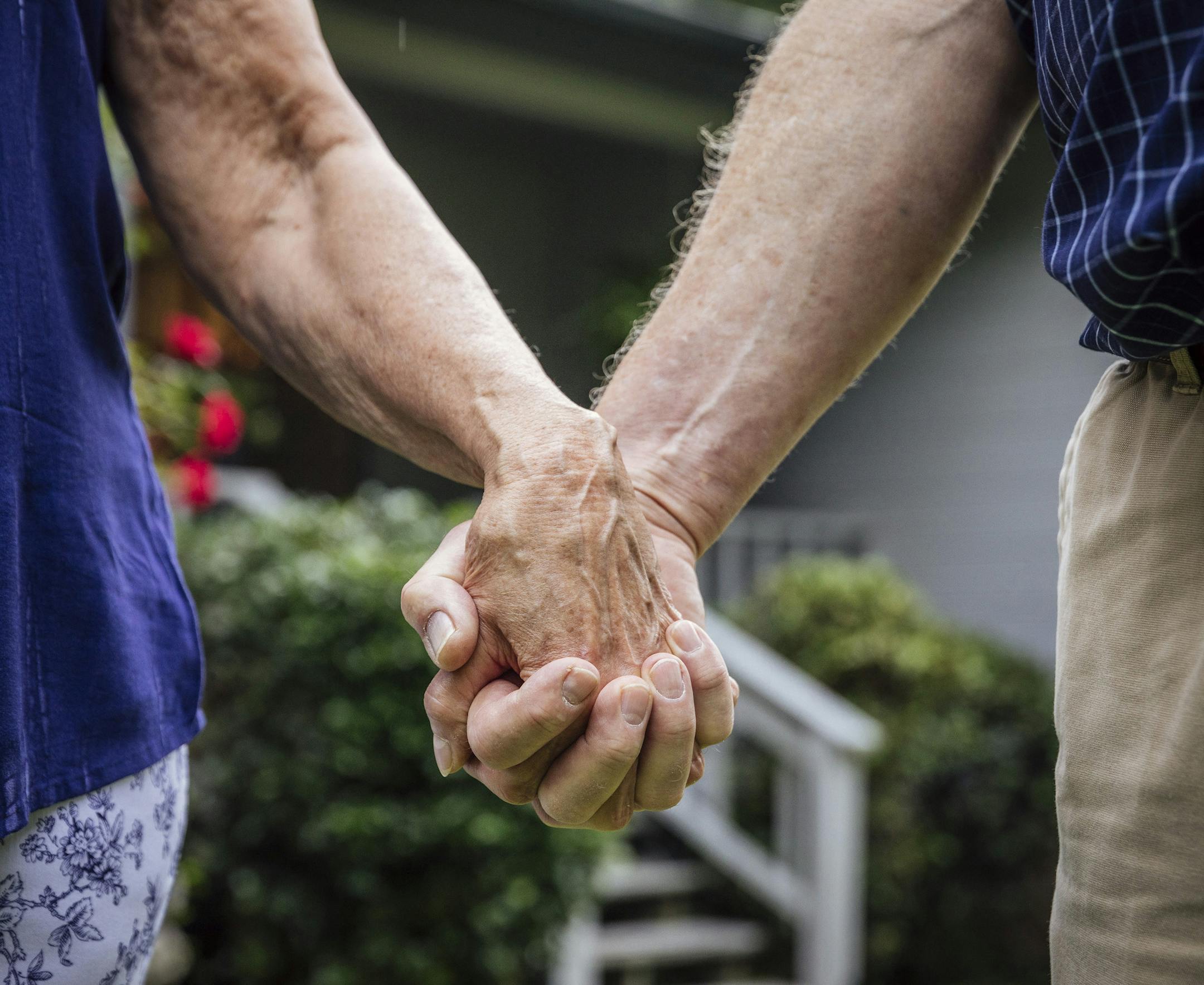FILE -- Glenn and LouJean Nelson hold hands in Tallahassee, Fla., May 26, 2018. There are steps retirees can take to lengthen the life of their savings, such as mindful spending, when markets are less than cooperative. (Audra Melton/The New York Times)