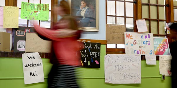 Barton Open School has seen a surge in diversity over the past few years. Here, a student and teacher pass by posters celebrating inclusion and divers