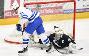 Minnetonka's Hagen Burrows (19) and Chanhassen's Kam Hendrickson tangle during the section final. On Sunday, Burrows and Hendrickson were honored as