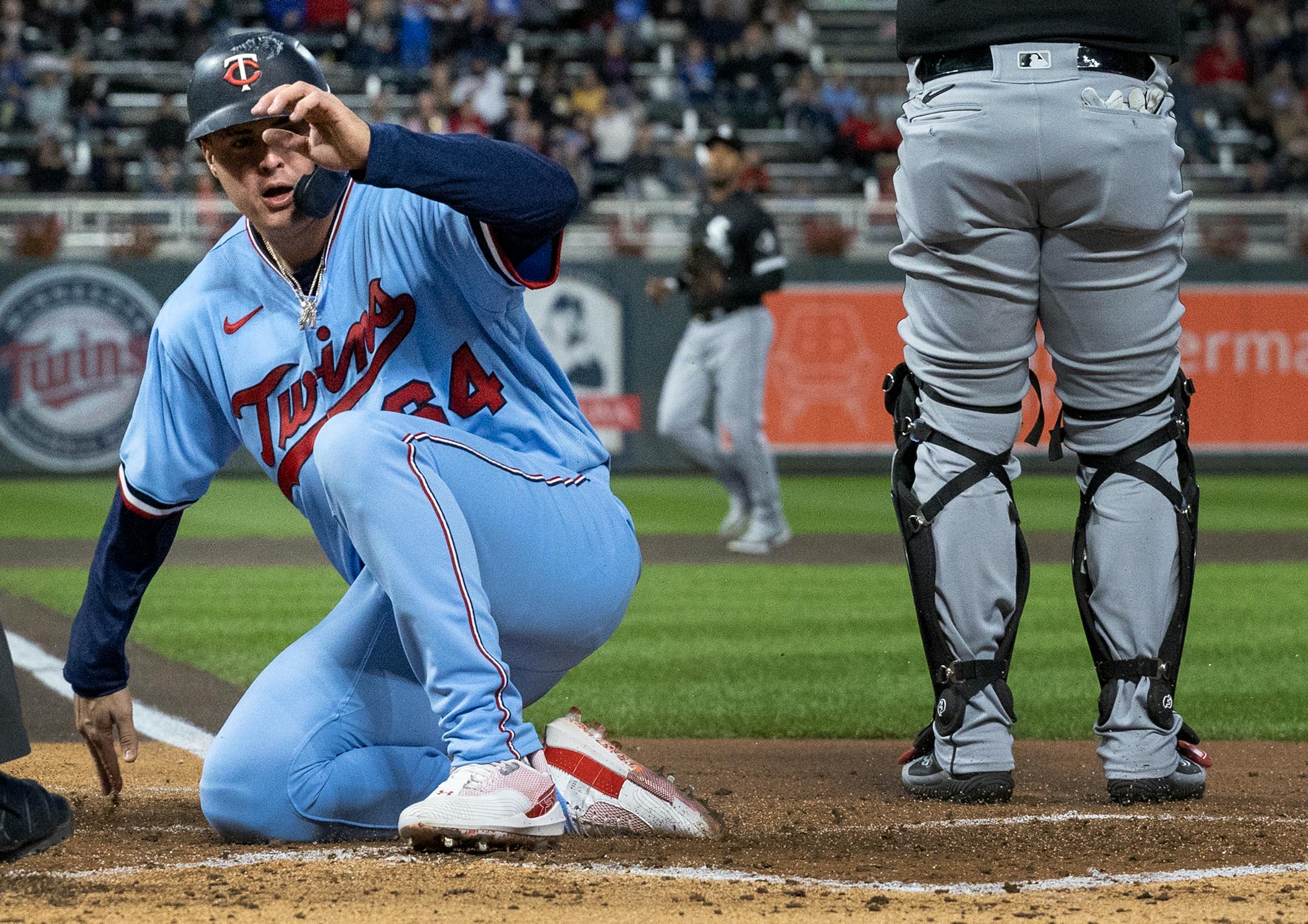 Jose Miranda of the Minnesota Twins scores in the first inning.