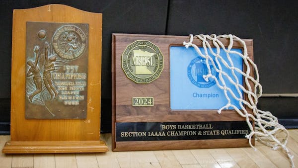 The 1937 region championship prize and the 2024 section championship plaque, side by side in Farmington.