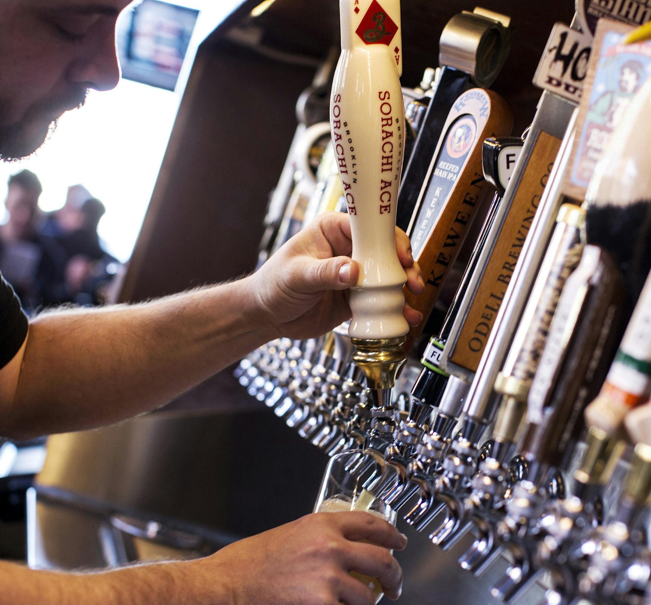 Eric Hellzen draws a beer from one of the 76 taps at the Happy Gnome in St. Paul.