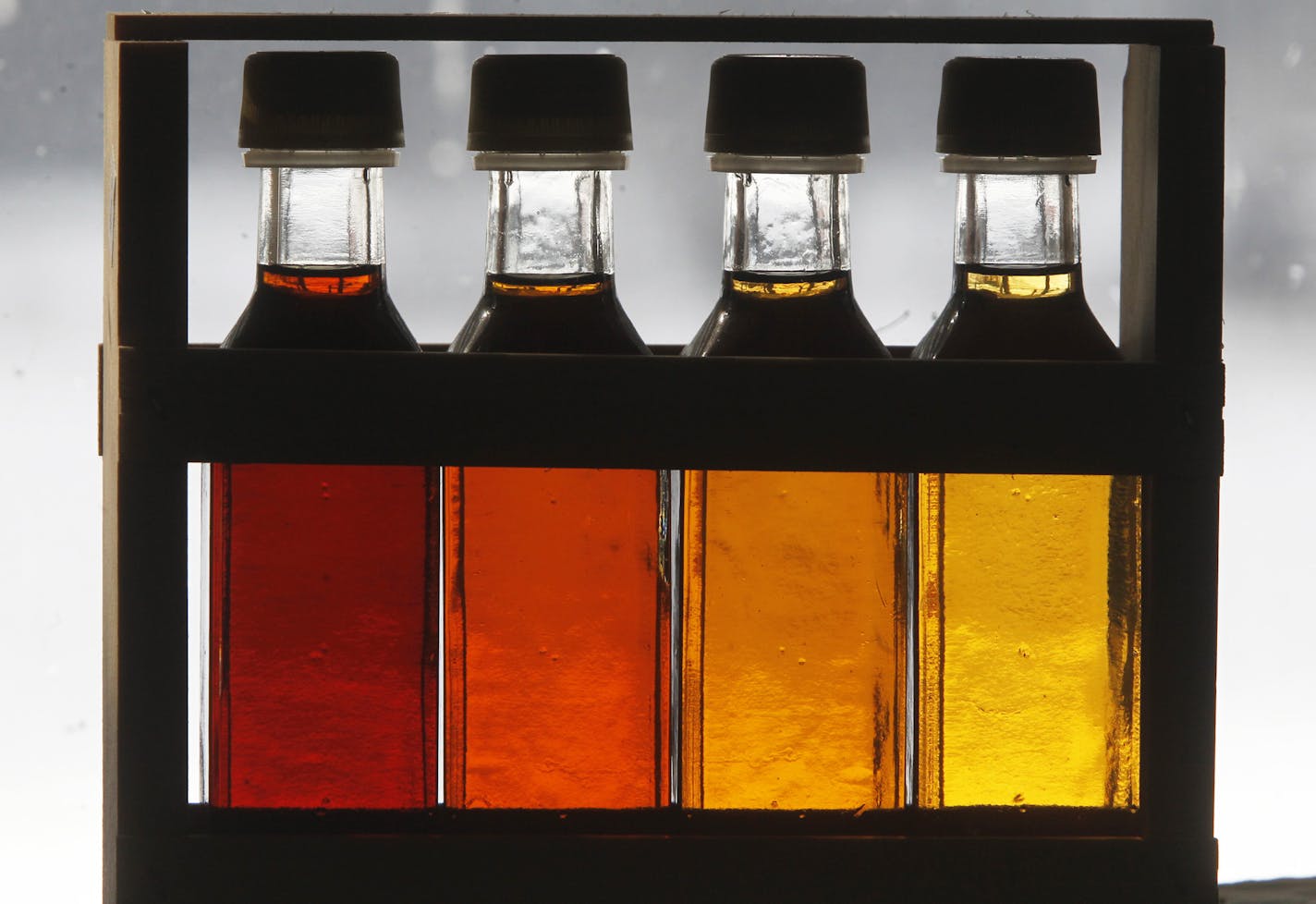 In this Friday, Feb. 15, 2013 photo, four grades of maple syrup are displayed in a gift box in East Montpelier, Vt. Vermont lawmakers are considering whether to drop the state's traditional maple labeling system in favor of an international one. (AP Photo/Toby Talbot)