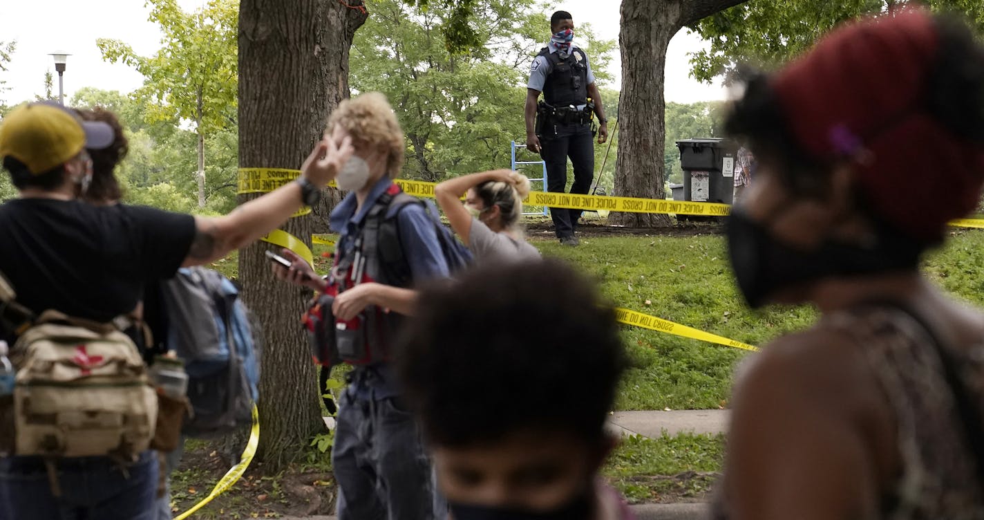 A Minneapolis park police officer stood guard after people living in a homeless encampment in Powderhorn Park were forced to leave Friday in Minneapolis.] DAVID JOLES • david.joles@startribune.com spot news**Demetrius Hall, cq