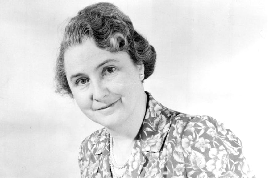 Black and white photo of Dr. Kathleen Jordan in a floral print dress.