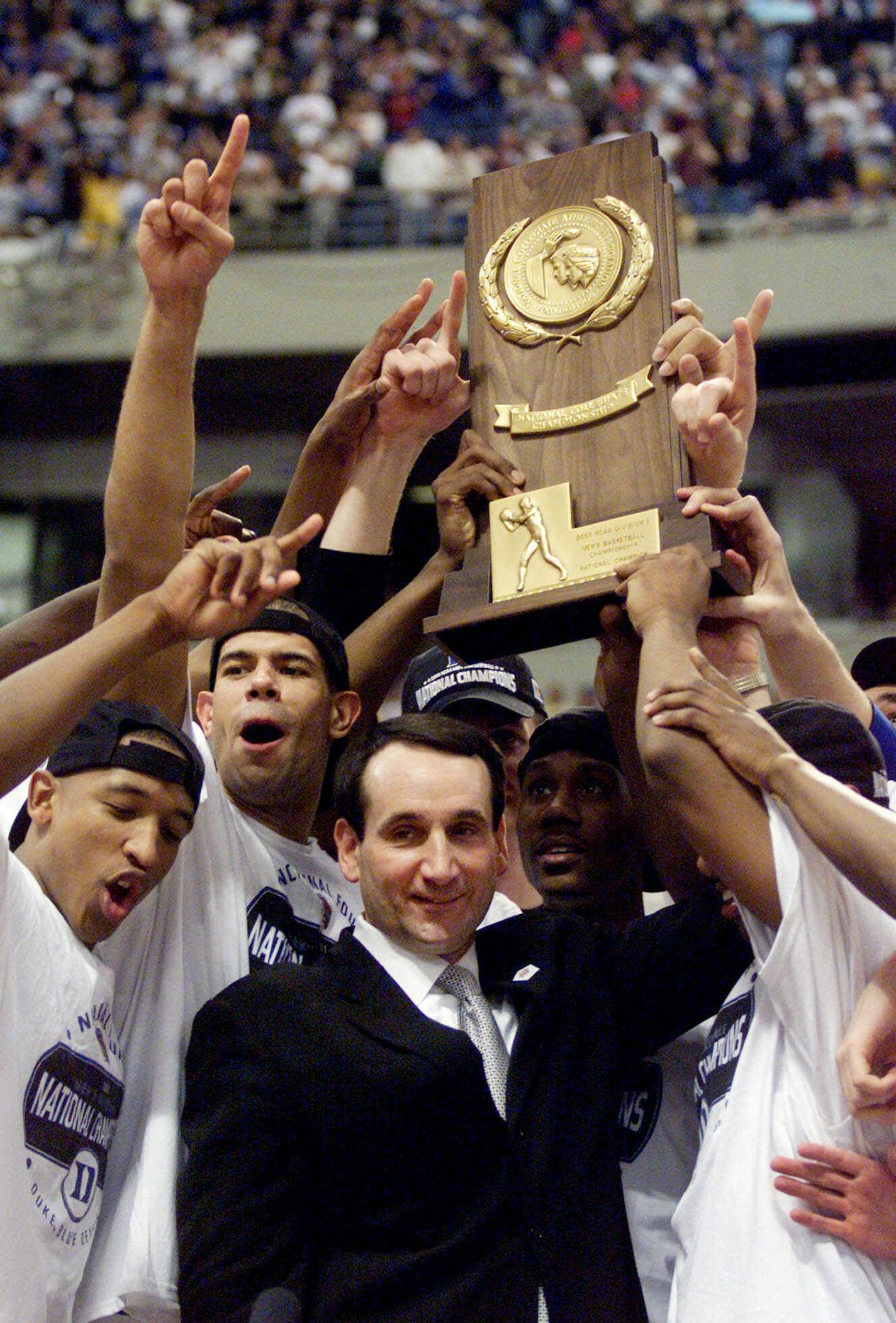 FILE - In this April 2, 2001, file photo, Duke coach Mike Krzyzewski and his Blue Devils hoist the championship trophy after beating Arizona 82-72 in the championship game of the Final Four in Minneapolis. His national championships came in 1991, 1992, 2001, 2010 and now 2015. (AP Photo/Bob Jordan, File) ORG XMIT: NY160