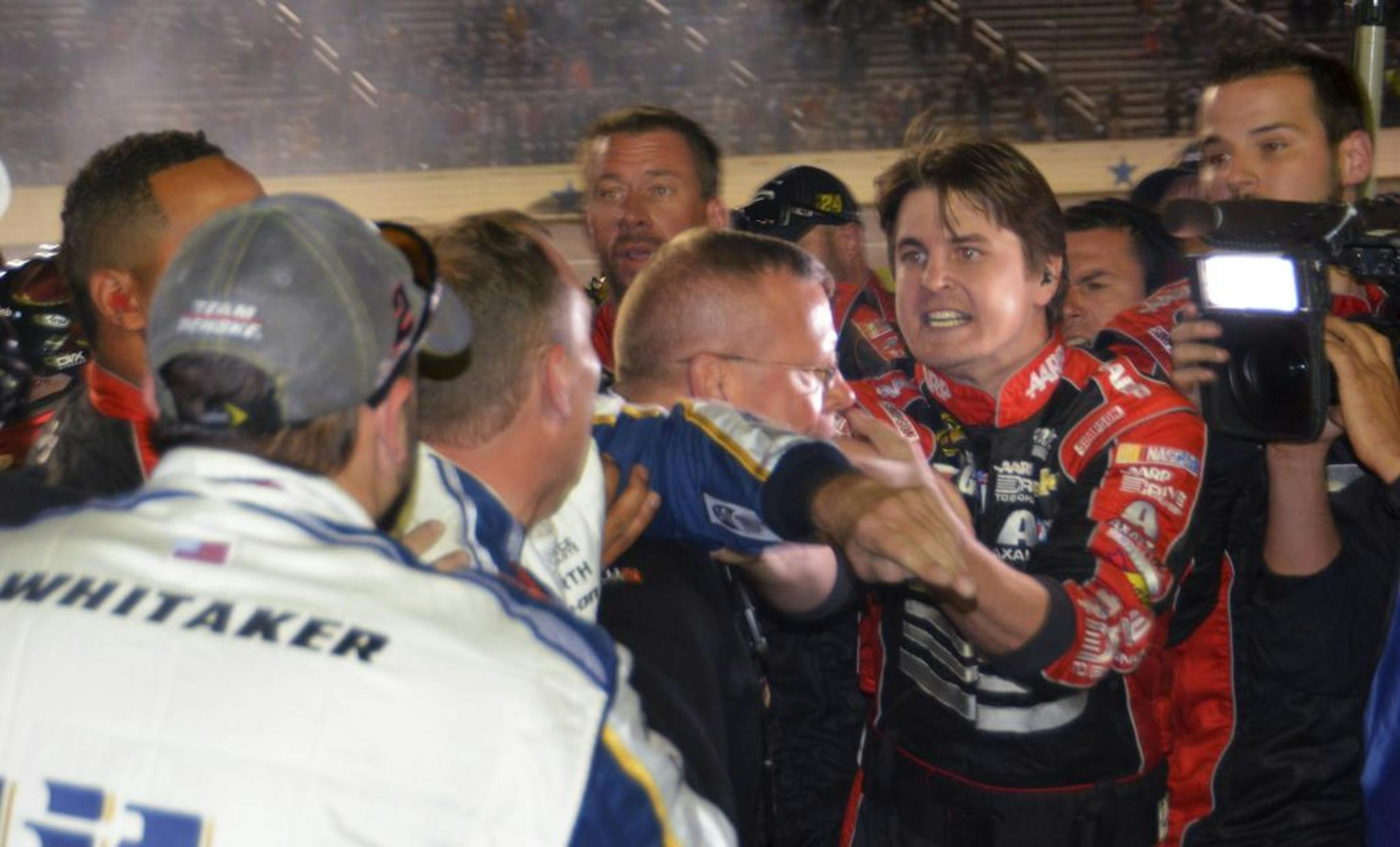 Pit crew members of drivers Jeff Gordon and Brad Keselowski fight on pit row after the end of the NASCAR Sprint Cup Series auto race at Texas Motor Speedway in Fort Worth, Texas, Sunday, Nov. 2, 2014. Keselowski made contact with Gordon's on a restart that knocked Gordon out of of the race.