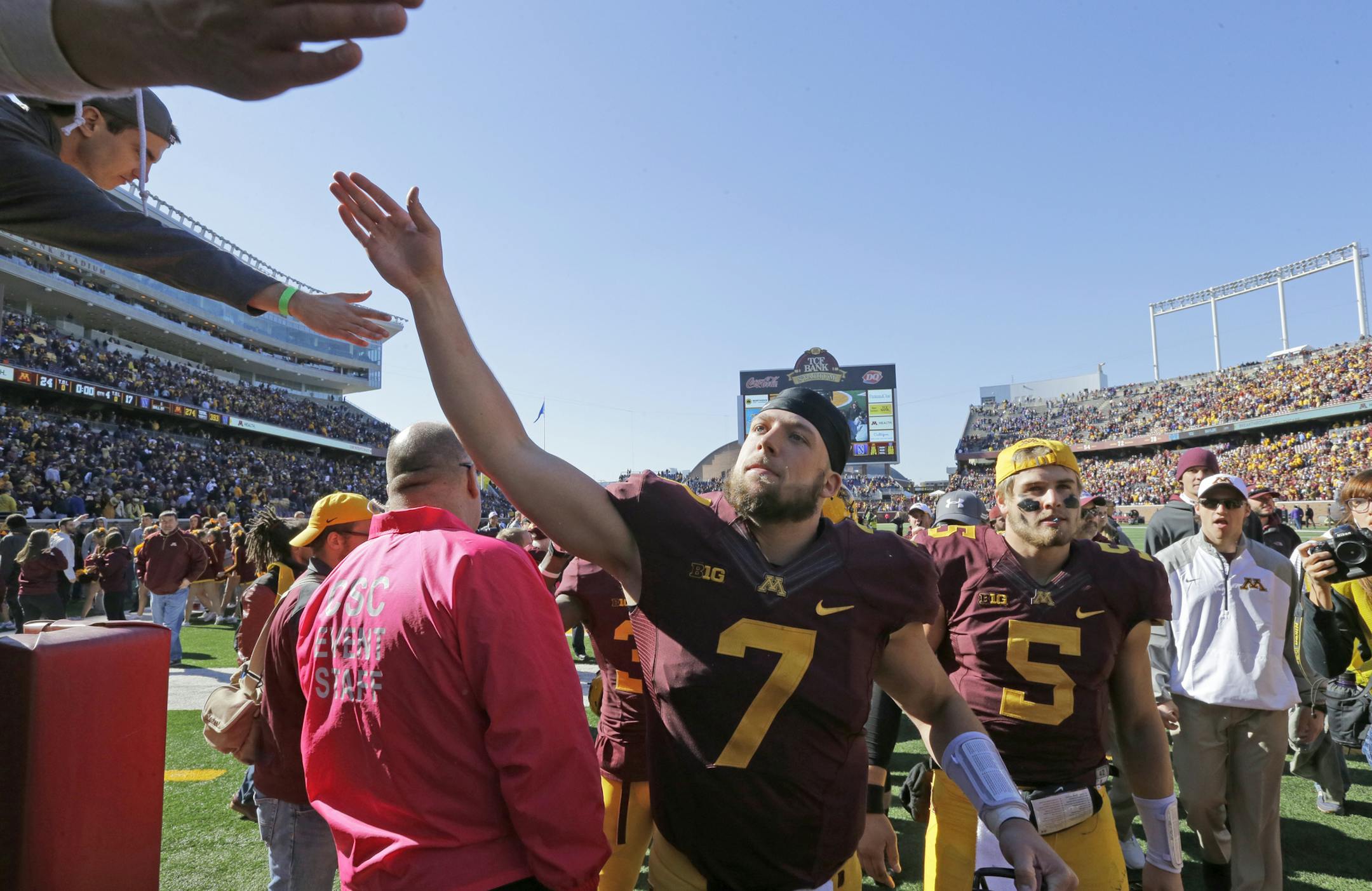 Minnesota quarterback Mitch Leidner (7) is congratulated by fans after Minnesota beat Northwestern 24-17 during an NCAA college football game in Minneapolis Saturday, Oct. 11, 2014. (AP Photo/Ann Heisenfelt)