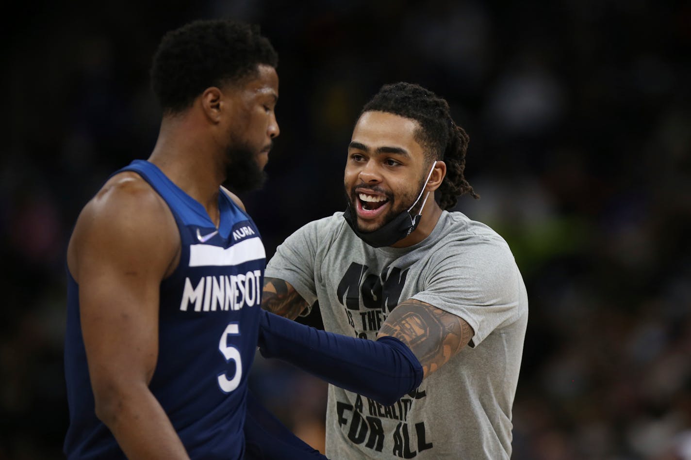 Minnesota Timberwolves guard D'Angelo Russell, right, reacts after teammate Malik Beasley's (5) three-point basket during the second half of an NBA basketball game against the Golden State Warriors, Sunday, Jan. 16, 2022, in Minneapolis. (AP Photo/Stacy Bengs)