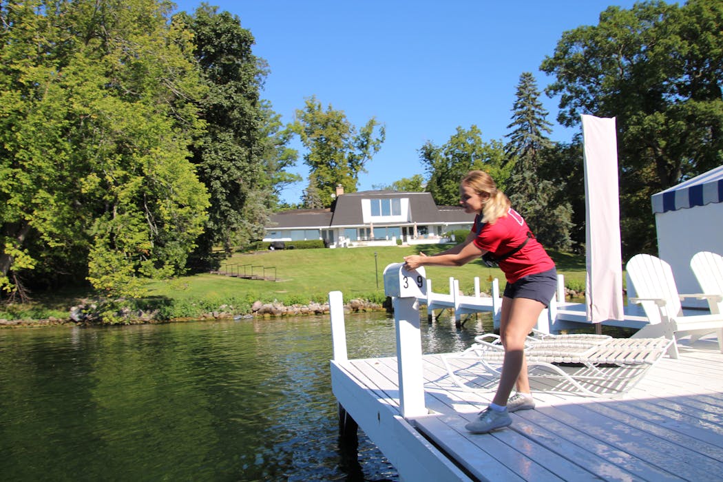 Paige Young, a so-called “mail jumper,” quickly bounds between land and boat to deliver the mail.