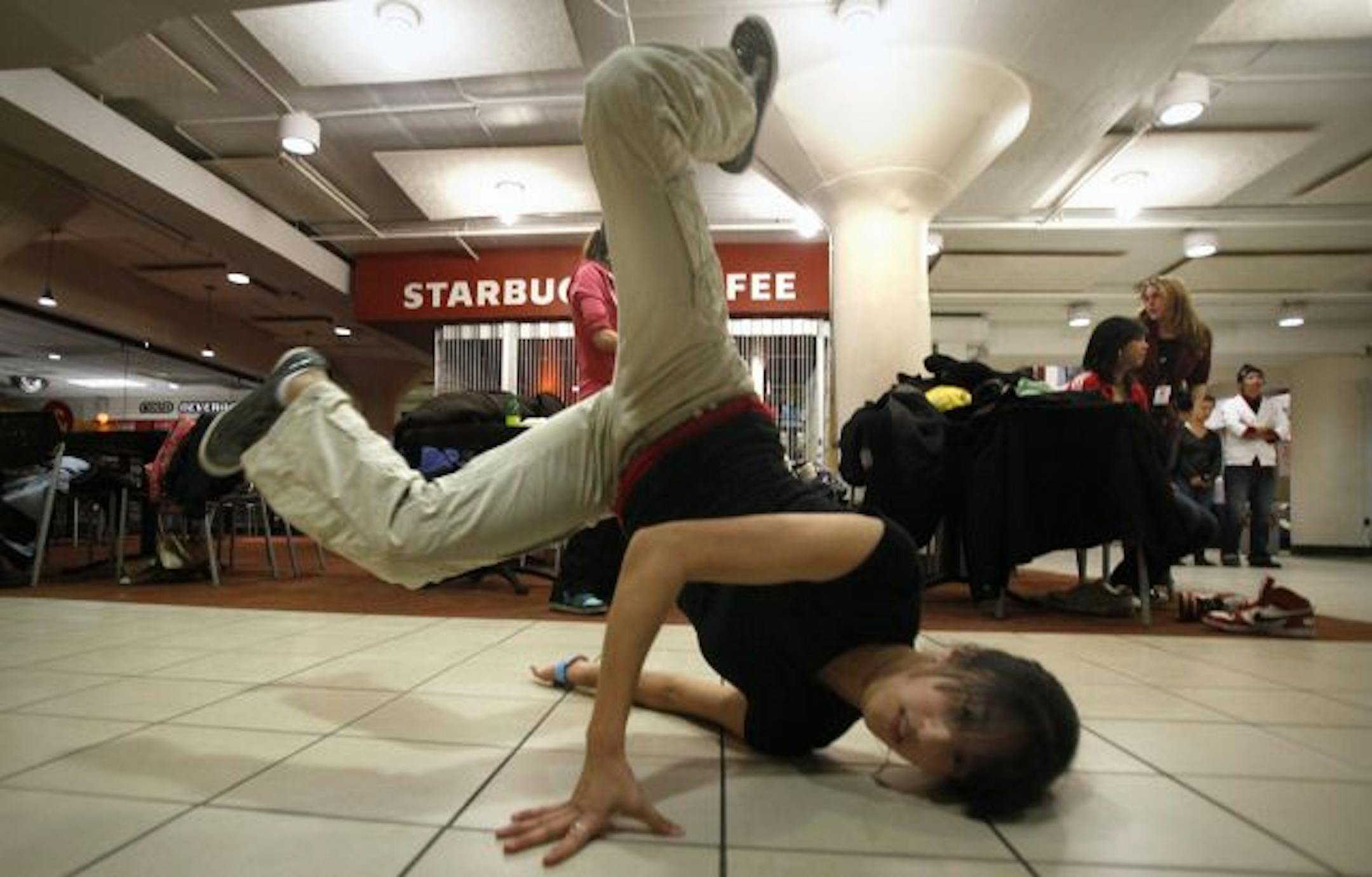 Helen Lin practiced some of her moves as other members of the breakdancing club at the U of M participated in the dancing demonstration.