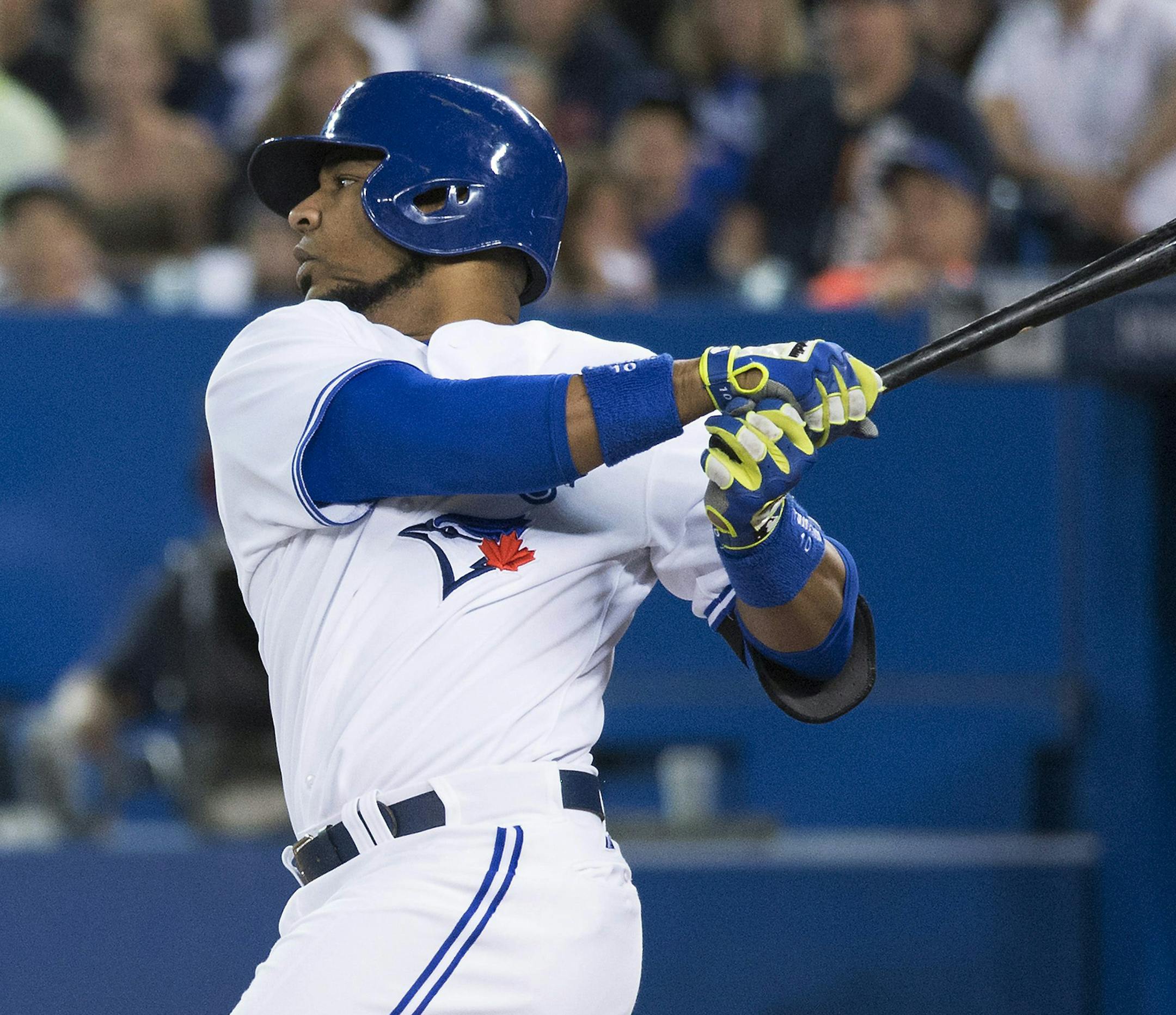 Toronto Blue Jays' Edwin Encarnacion follows through on a two-run single against the Tampa Bay Rays in the first inning of a baseball game in Toronto on Wednesday, May 28, 2014. (AP Photo/The Canadian Press, Darren Calabrese)