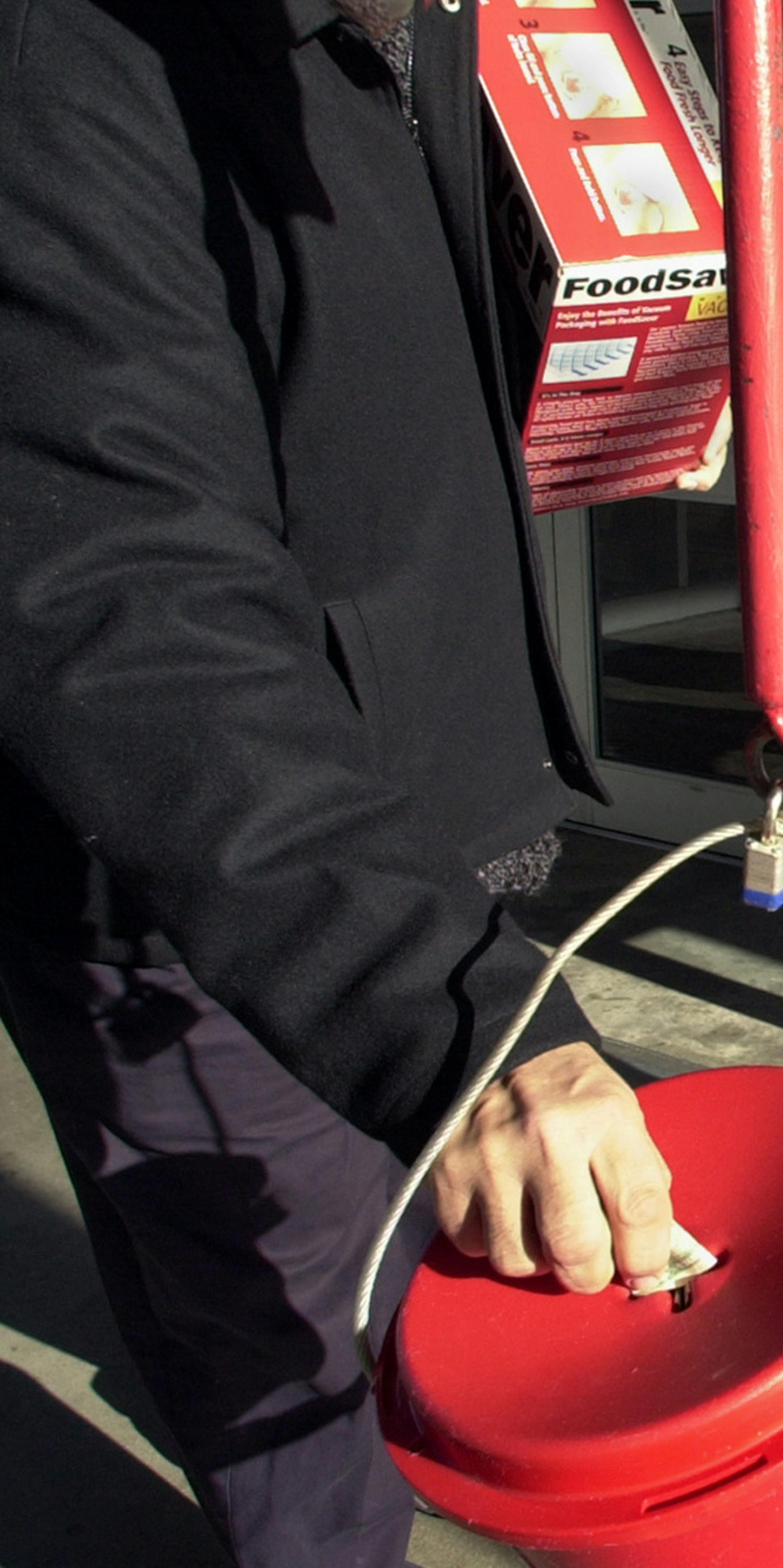 Bloomington, Mn., Tues., Dec. 3, 2002--Salvation Army bell ringer Jimmy Briguglio (cq.) holds the door open for shoppers at the Mall of America West Market entrance as a donation is placed in the red kettle. Donations are down this holiday season for the Salvation Army. Briguglio opened doors, wished everyone a great day and told them, "God bless you."
GENERAL INFORMATION: Profiles of two Salvation Army bell ringers at the Mall of America.